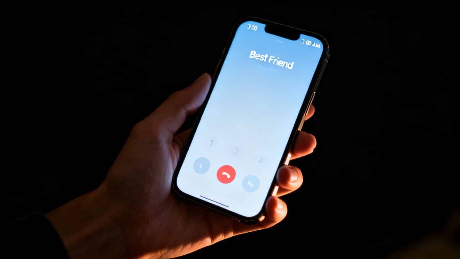 A hand holds a glowing smartphone showing an incoming call from 'Best Friend' at 3 AM.
